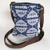 Less Is More- Ornamento in White on Blue Cross Body Bag
